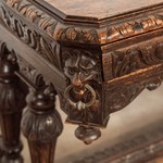 Антикварный стол темного дуба с рельефной резьбой 1860-х гг. 