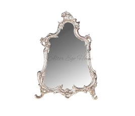 Серебряное зеркало в фигурной раме
